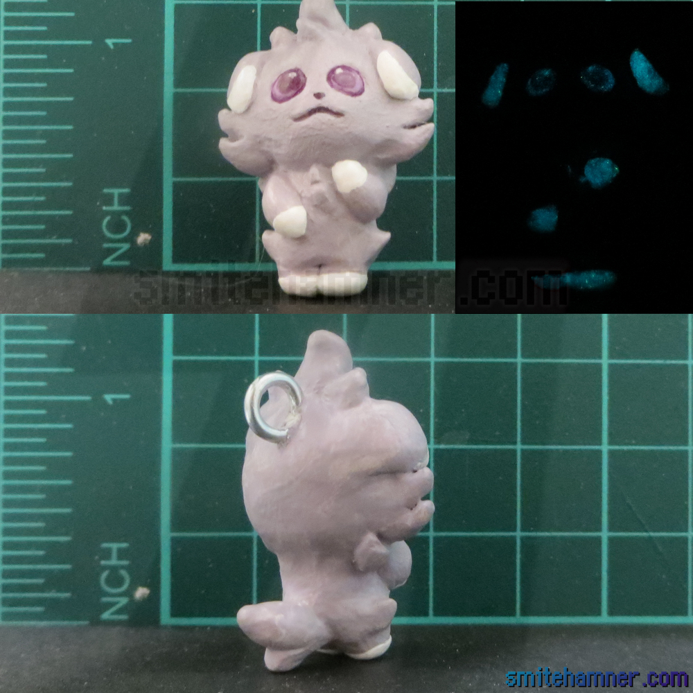 A few pictures showing different angles of a 1 inch tall espurr sculpt. One picture shows that the eyes, ears, and paws glow in the dark.
